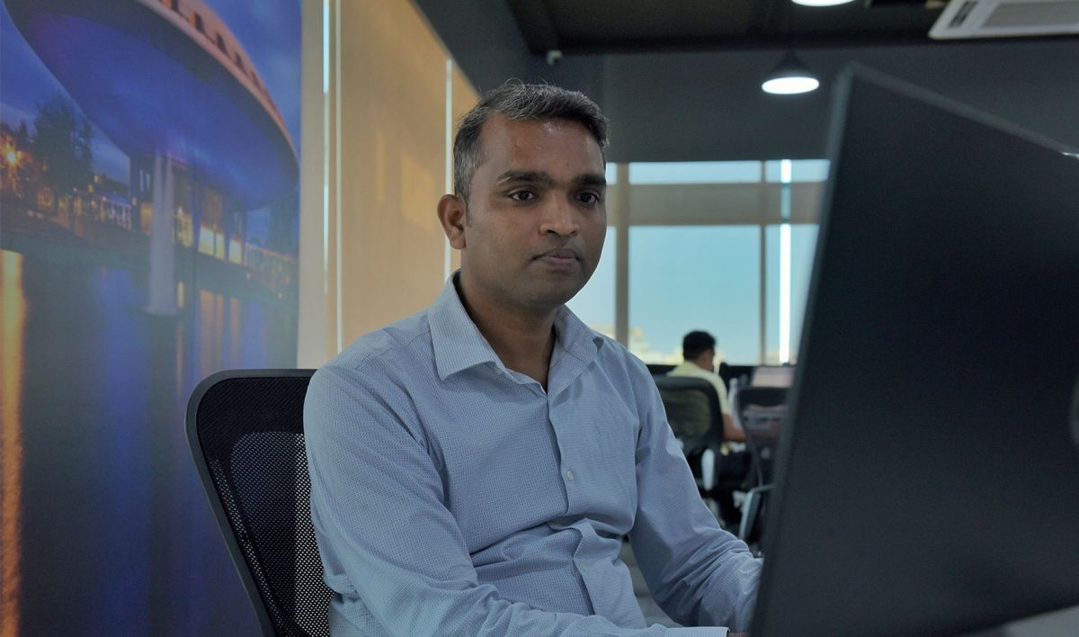 Big Data professional werkt geconcentreerd achter computer met stedelijke achtergrond, illustrerend voor internationale connectiviteit en expertise in data-oplossingen.